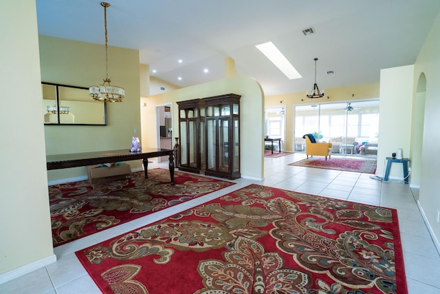 165 Cypress Trce, Royal Palm Beach, FL 33411 - foyer entrance with tile patterned floors, a chandelier, lofted ceiling, baseboards, and arched walkways
