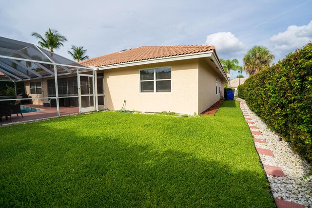 165 Cypress Trce, Royal Palm Beach, FL 33411 - rear view of property featuring stucco siding, a tile roof, a lawn, a patio, and an outdoor pool