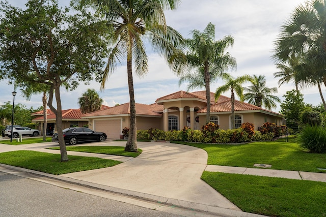 165 Cypress Trce, Royal Palm Beach, FL 33411 - mediterranean / spanish home with stucco siding, a garage, concrete driveway, and a tiled roof