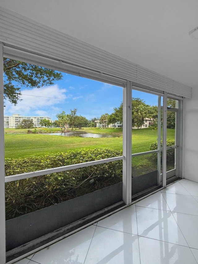 unfurnished sunroom with a water view