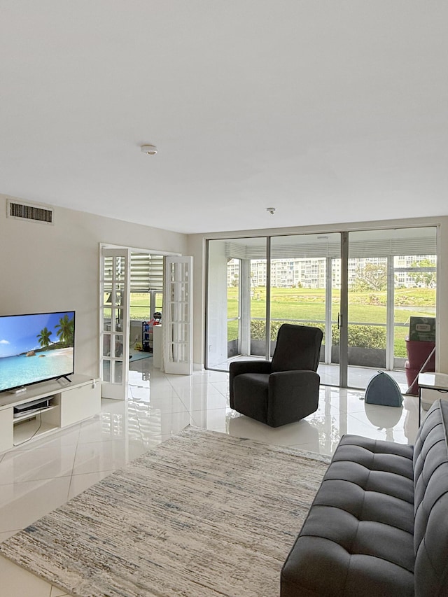 tiled living room featuring french doors