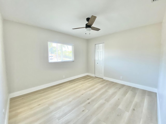 unfurnished room with ceiling fan and light wood-type flooring