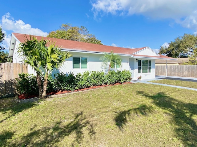 ranch-style house with a carport and a front yard