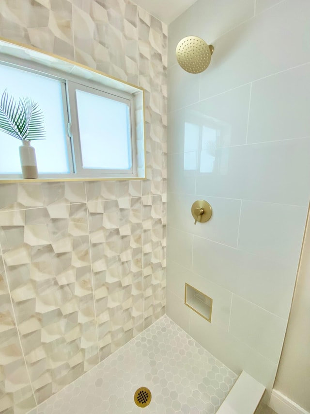 bathroom with tiled shower