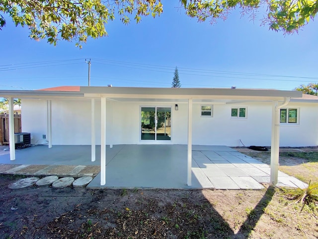 back of house with central AC unit and a patio area