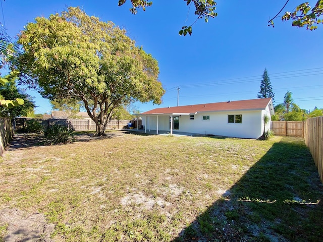 rear view of house featuring a lawn