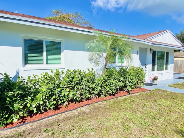 view of property exterior with a lawn