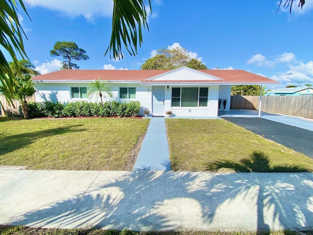 view of front of property with a carport and a front yard