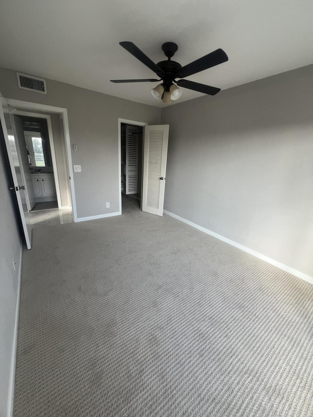 unfurnished bedroom featuring carpet floors, a closet, and ceiling fan