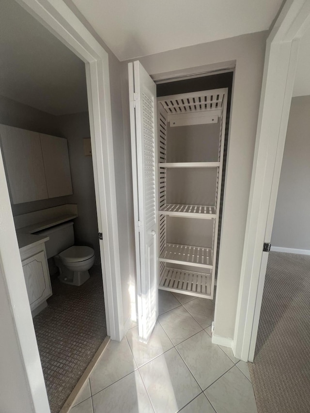 bathroom featuring tile patterned floors and toilet