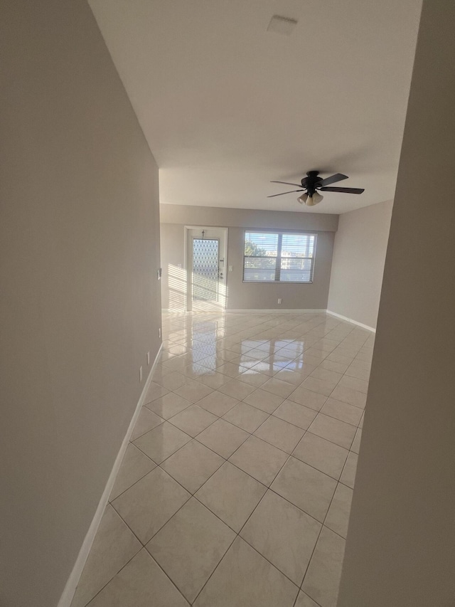 unfurnished room with light tile patterned flooring and ceiling fan