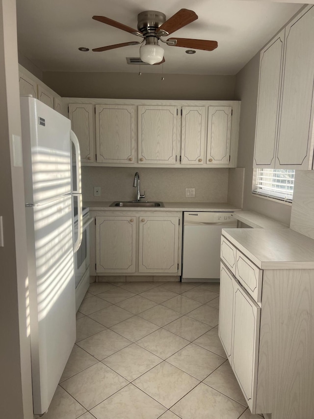 kitchen with sink, white appliances, light tile patterned floors, ceiling fan, and backsplash