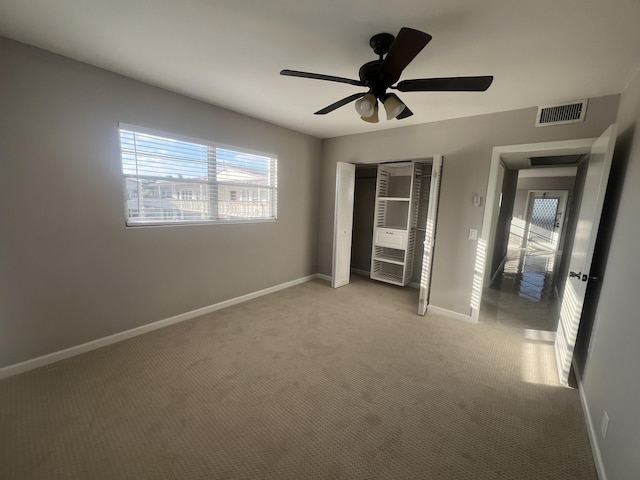 unfurnished bedroom with light carpet and ceiling fan