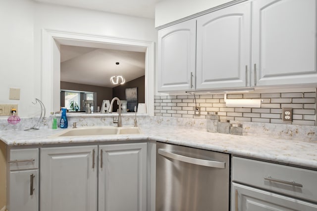 kitchen with sink, stainless steel dishwasher, white cabinets, and backsplash