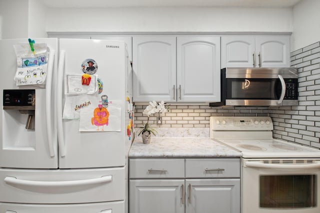 kitchen with white cabinetry, white appliances, and backsplash