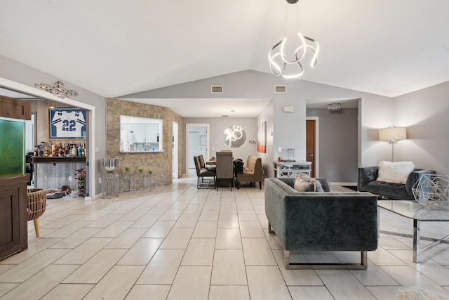 tiled living room featuring lofted ceiling and an inviting chandelier