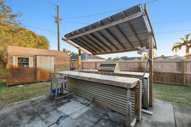 view of patio with an outdoor structure and area for grilling