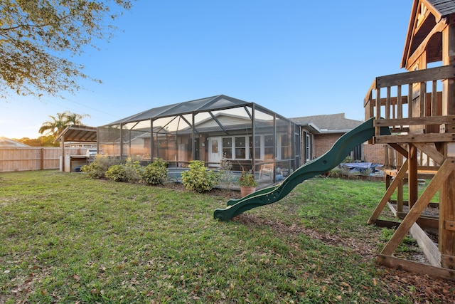 view of yard featuring a playground and a lanai