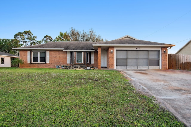 ranch-style house featuring a garage and a front yard