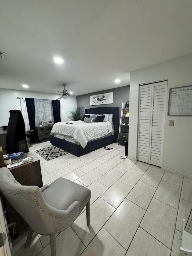 bedroom with ceiling fan and a closet