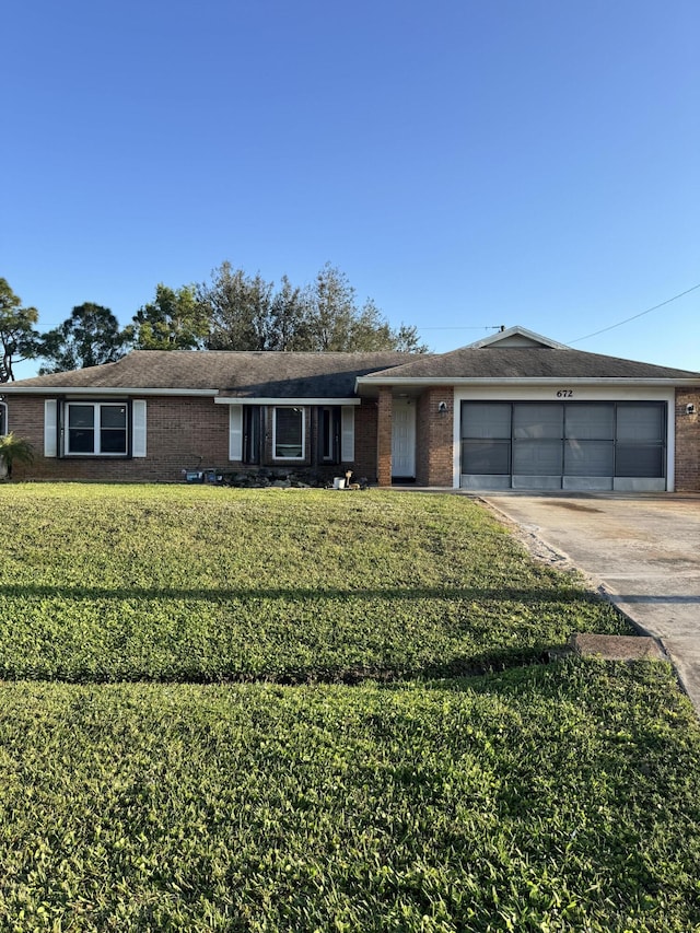 single story home with a garage and a front lawn