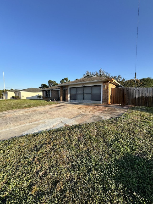 ranch-style home featuring a garage and a front yard