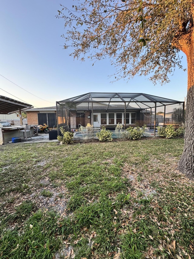 view of yard with a patio and glass enclosure