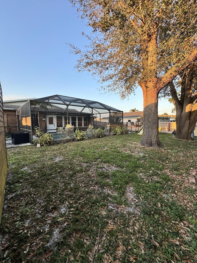 view of yard featuring glass enclosure