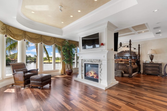 sitting room with a raised ceiling, coffered ceiling, and dark wood-type flooring