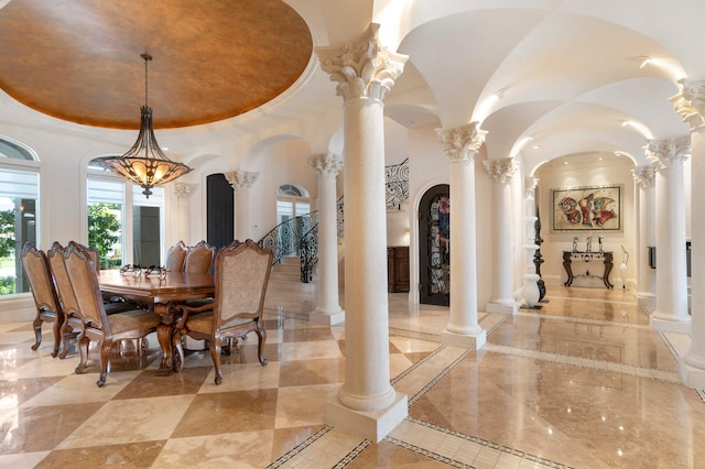 dining area with an inviting chandelier and ornate columns