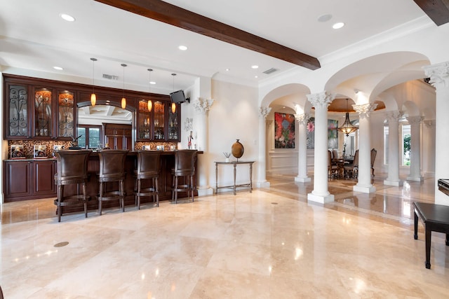 bar featuring beamed ceiling, tasteful backsplash, hanging light fixtures, and ornate columns