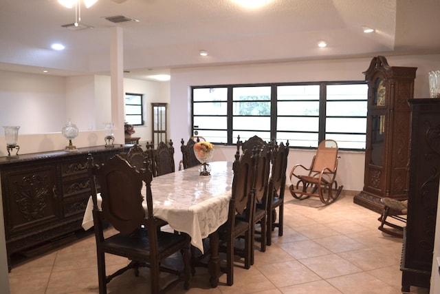 dining area with light tile patterned floors, bar with sink, and recessed lighting
