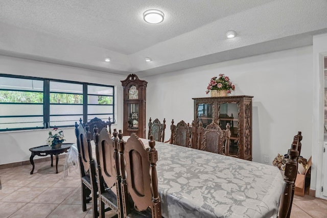 dining room featuring light tile patterned flooring, a textured ceiling, recessed lighting, and baseboards