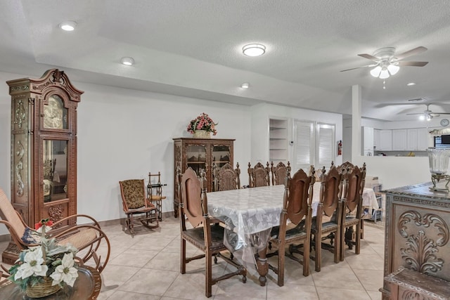 dining room featuring light tile patterned floors, ceiling fan, and a textured ceiling