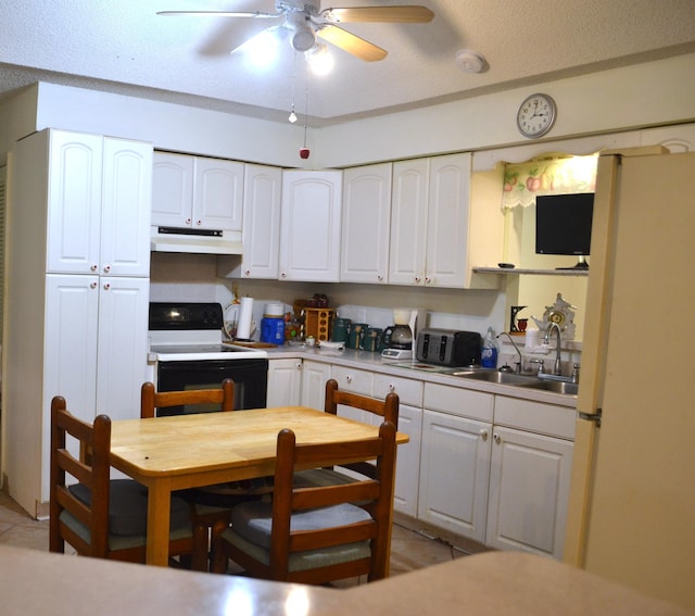 kitchen with range with electric stovetop, under cabinet range hood, a ceiling fan, white cabinets, and freestanding refrigerator