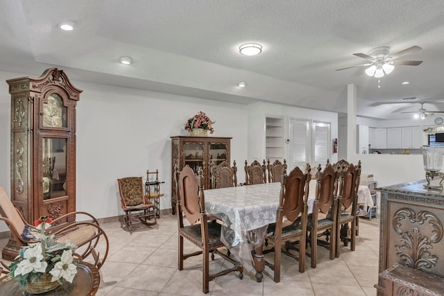 tiled dining space featuring a textured ceiling