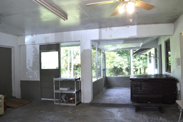 sunroom / solarium with ceiling fan, healthy amount of natural light, and a jacuzzi