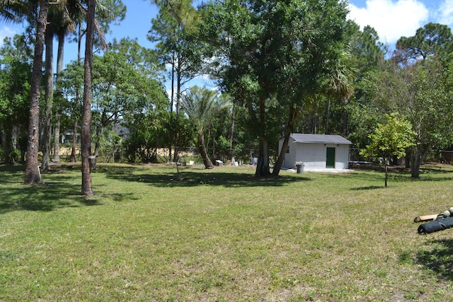 view of yard featuring an outbuilding and a storage shed