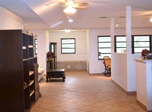 hallway featuring light tile patterned floors, plenty of natural light, and recessed lighting