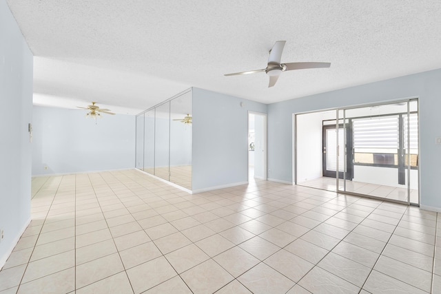 spare room with ceiling fan, a textured ceiling, and light tile patterned floors