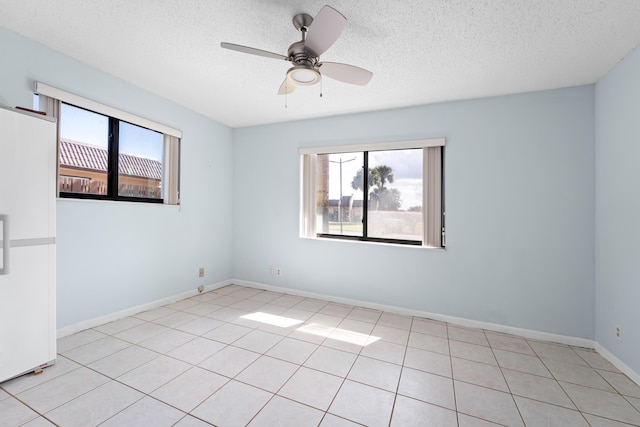 empty room with a textured ceiling and ceiling fan