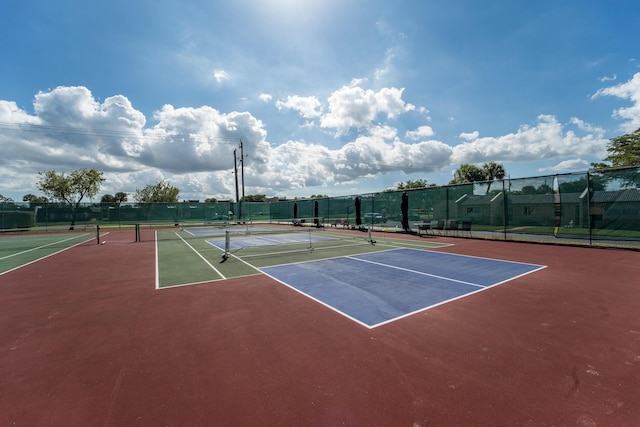 view of tennis court with basketball hoop