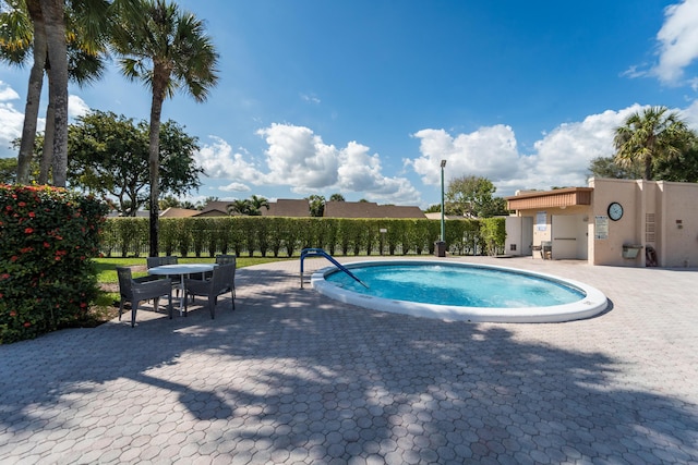 view of swimming pool with a patio area