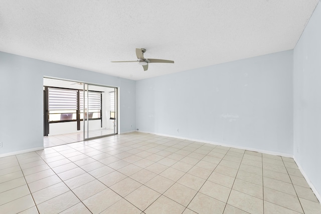 tiled empty room featuring a textured ceiling and ceiling fan