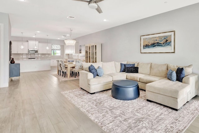 living room featuring visible vents, recessed lighting, light wood-type flooring, and a ceiling fan