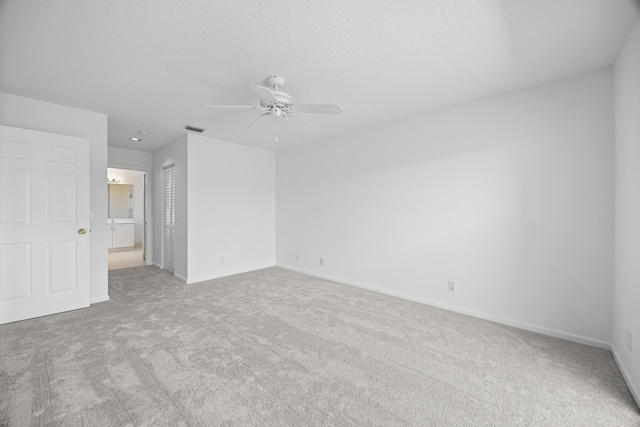 interior space featuring light colored carpet and ceiling fan