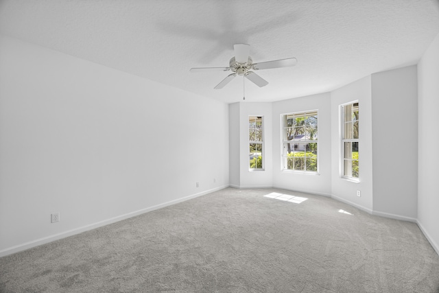 unfurnished room with ceiling fan, carpet, and a textured ceiling