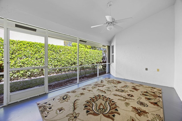 unfurnished sunroom featuring vaulted ceiling and ceiling fan