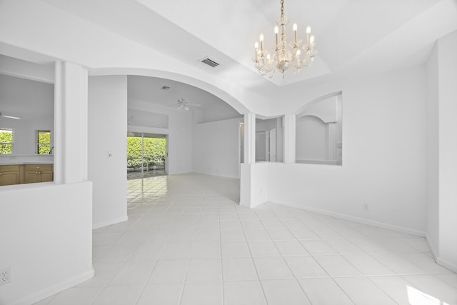 empty room with ceiling fan with notable chandelier and light tile patterned floors