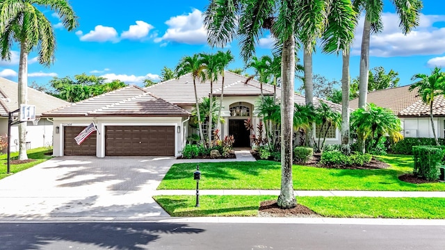 mediterranean / spanish-style house with a front lawn and a garage